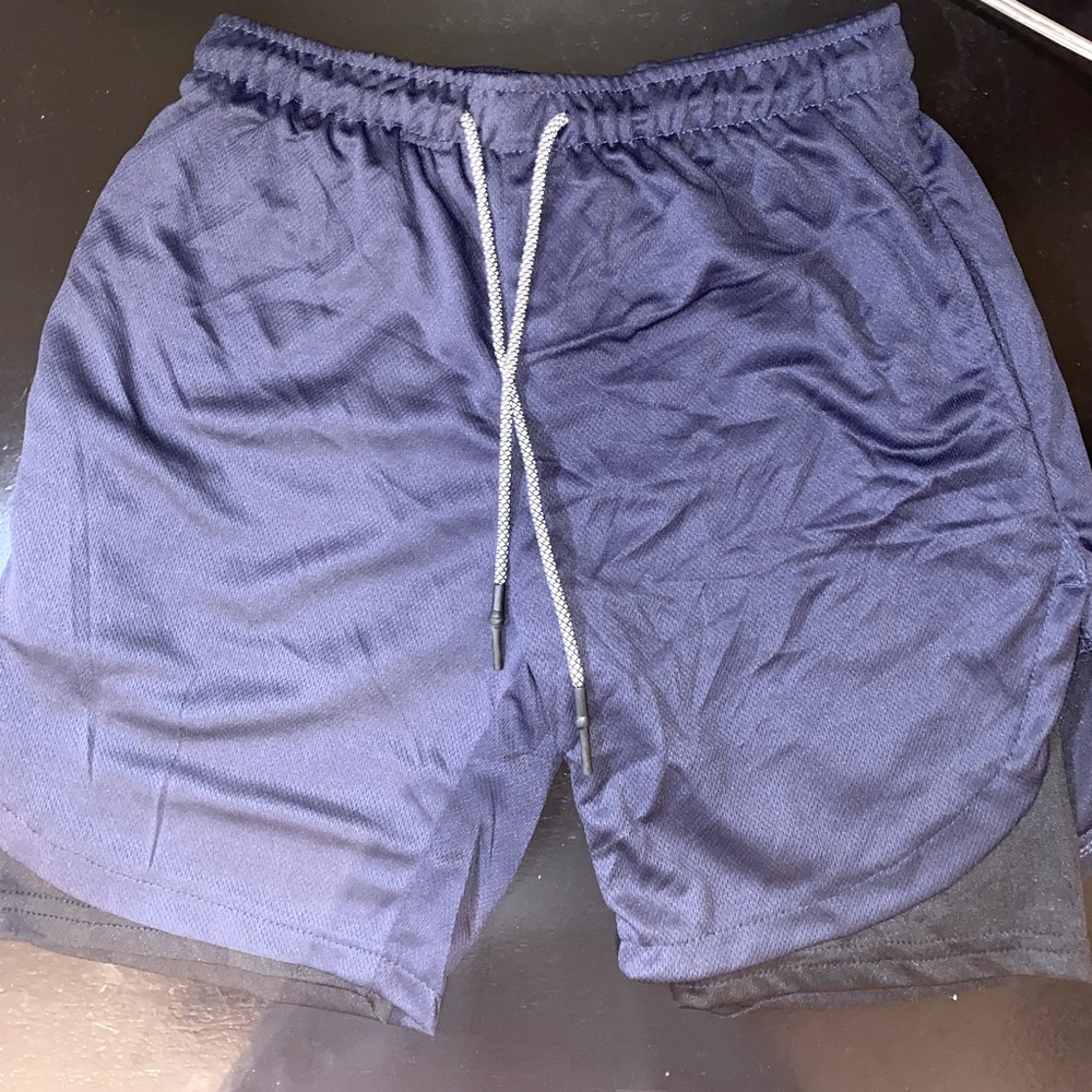 New men’s athletic shorts. Size Medium in the color Blue